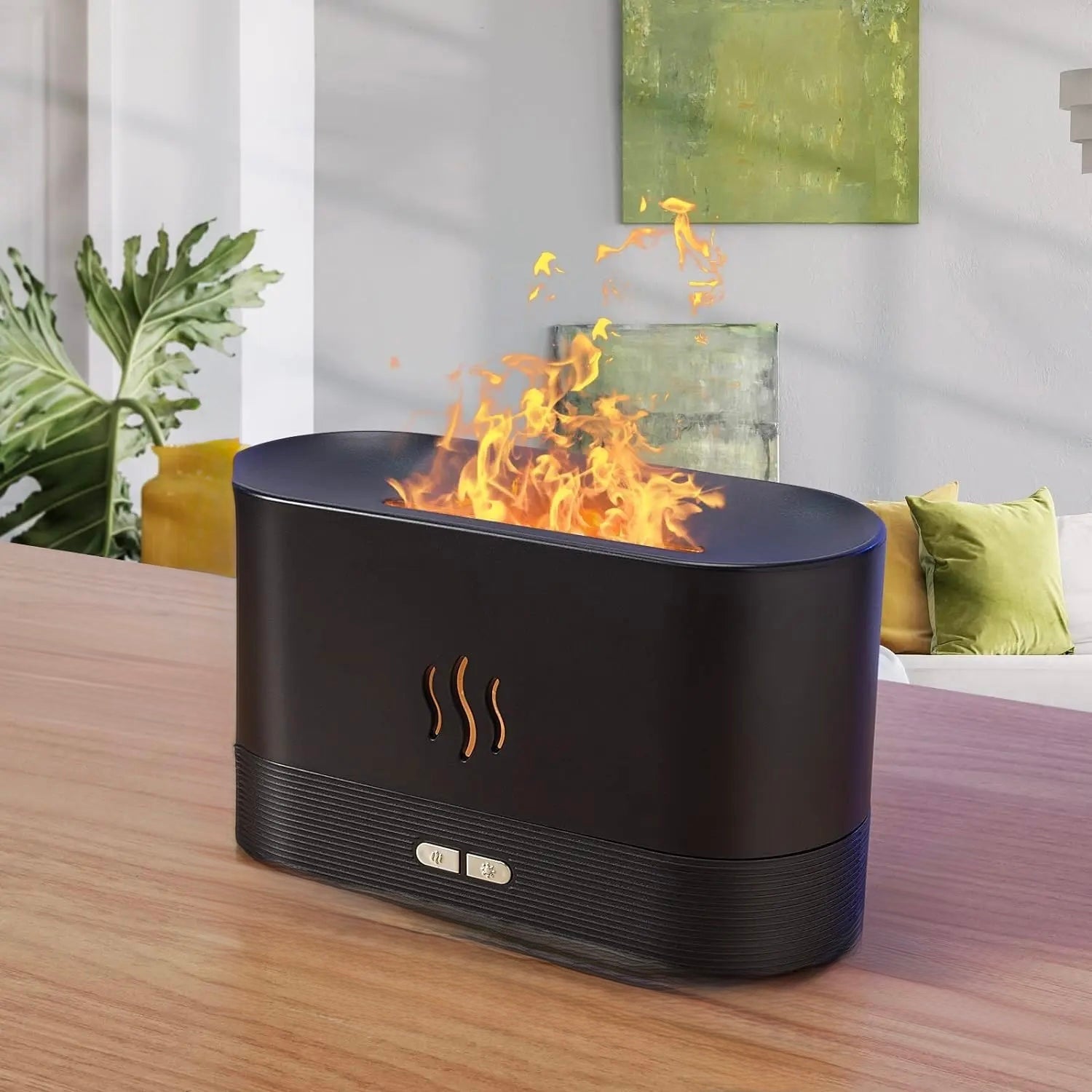 Black water flame aromatherapy diffuser with warm glowing mist beside a small plant