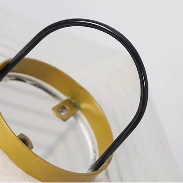 Close-up of the metal ring and black wire handle on a rice paper floor lamp