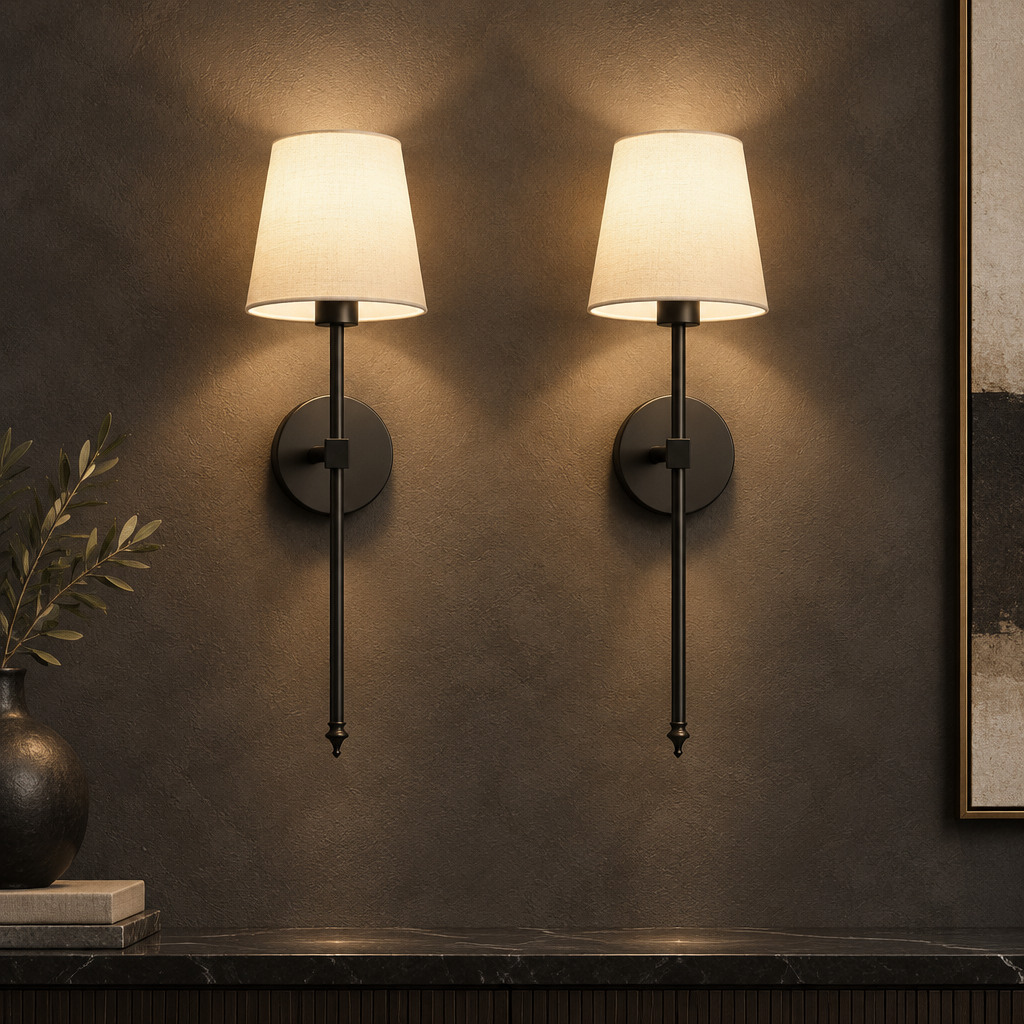 Pair of black wall sconces with white tapered shades.