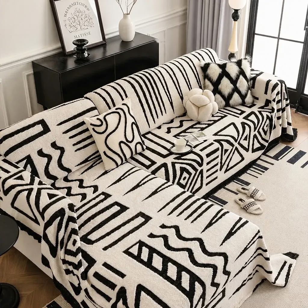 White tribal print sofa cover on L-shaped couch with cushions
