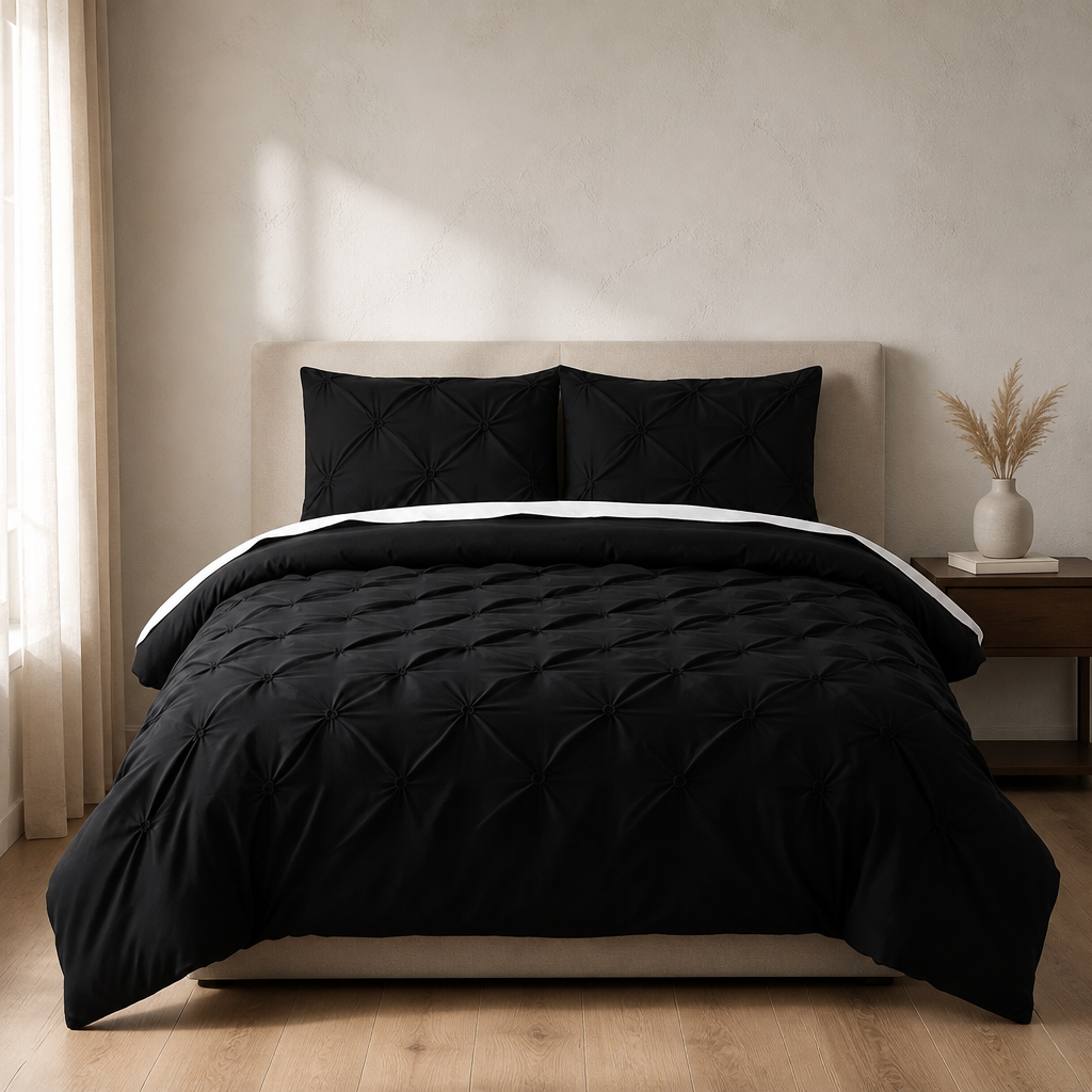 Black pintuck duvet set with matching pillowcases dressed on a double bed in a warm contemporary bedroom