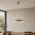 Modern Chrome pendant light hanging above a dining table with a neutral background