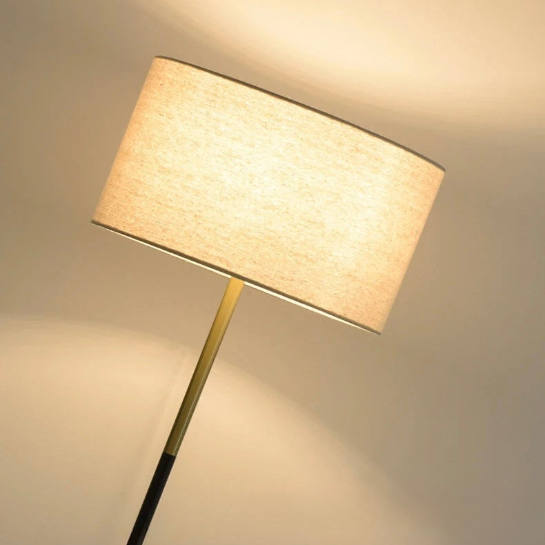 Detailed view of the fabric lampshade illuminated with warm light, highlighting the soft texture.