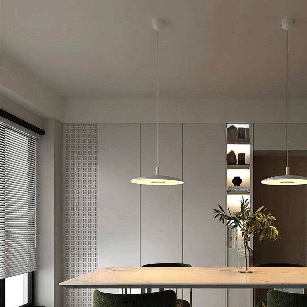 Modern dining area with a table and chairs in a stylish interior setting.