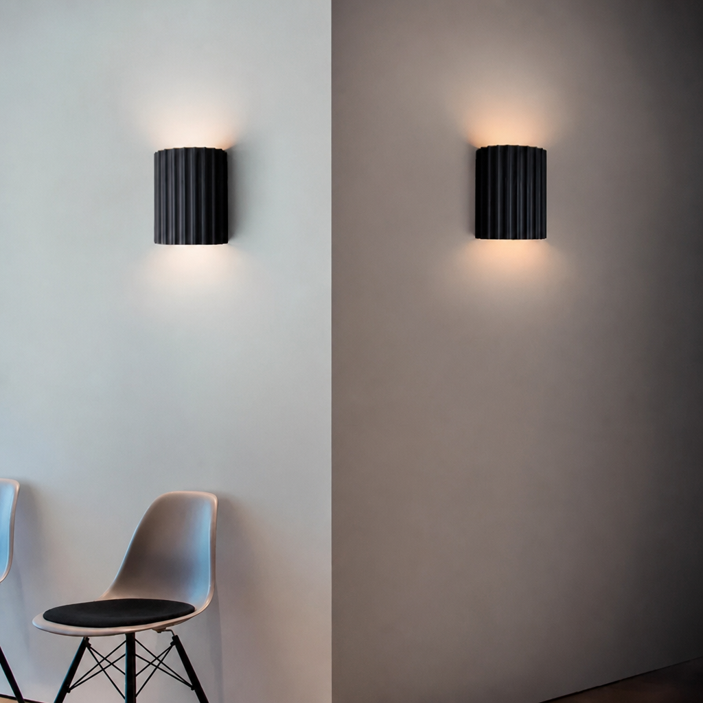 Grey ribbed resin wall lamp with fluted half-cylinder shade.