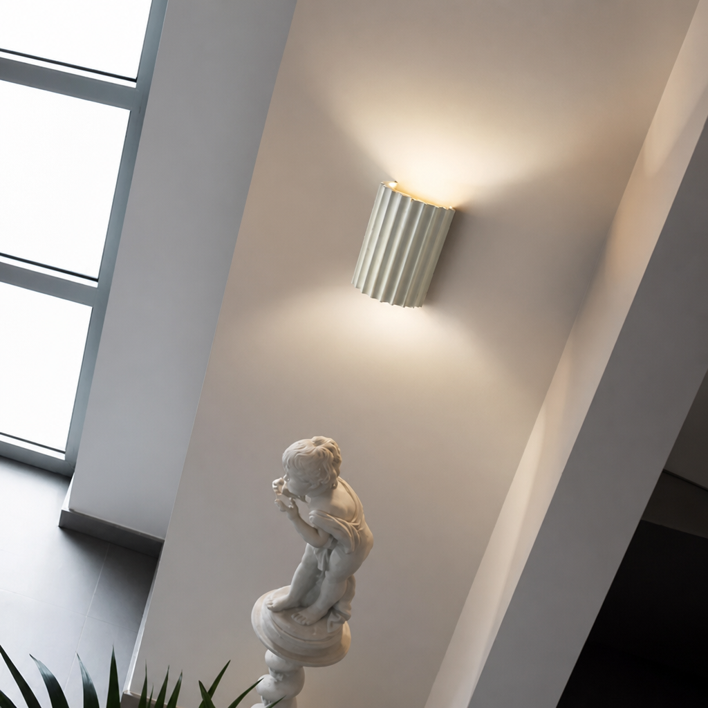 White ribbed resin wall lamp with smooth fluted texture.