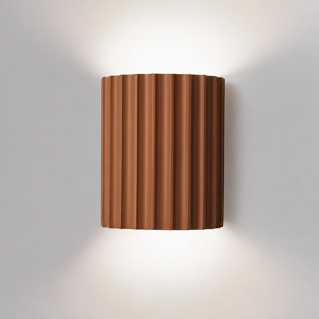 Orange ribbed resin wall lamp with warm-toned fluted shade.