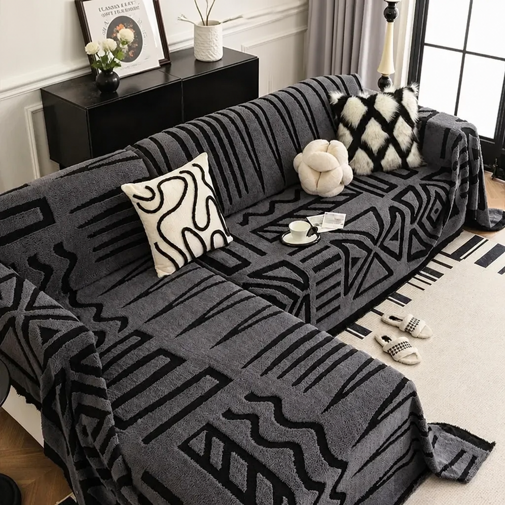 Dark Grey tribal print sofa cover on L-shaped couch with cushions