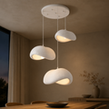 Three Wabi-Sabi pebble pendant lights hanging in a cluster with a size guide