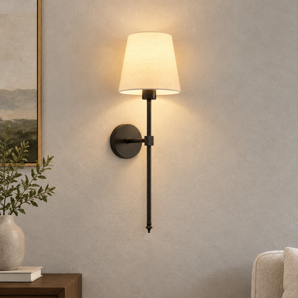 Single black wall sconce with white tapered shade.