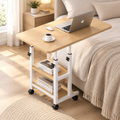 Natural wood mobile desk with white frame, 60 × 40 cm, beside a bed with a laptop and coffee on top