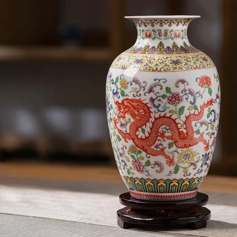 Traditional white porcelain vase featuring a large red imperial dragon and floral vines.