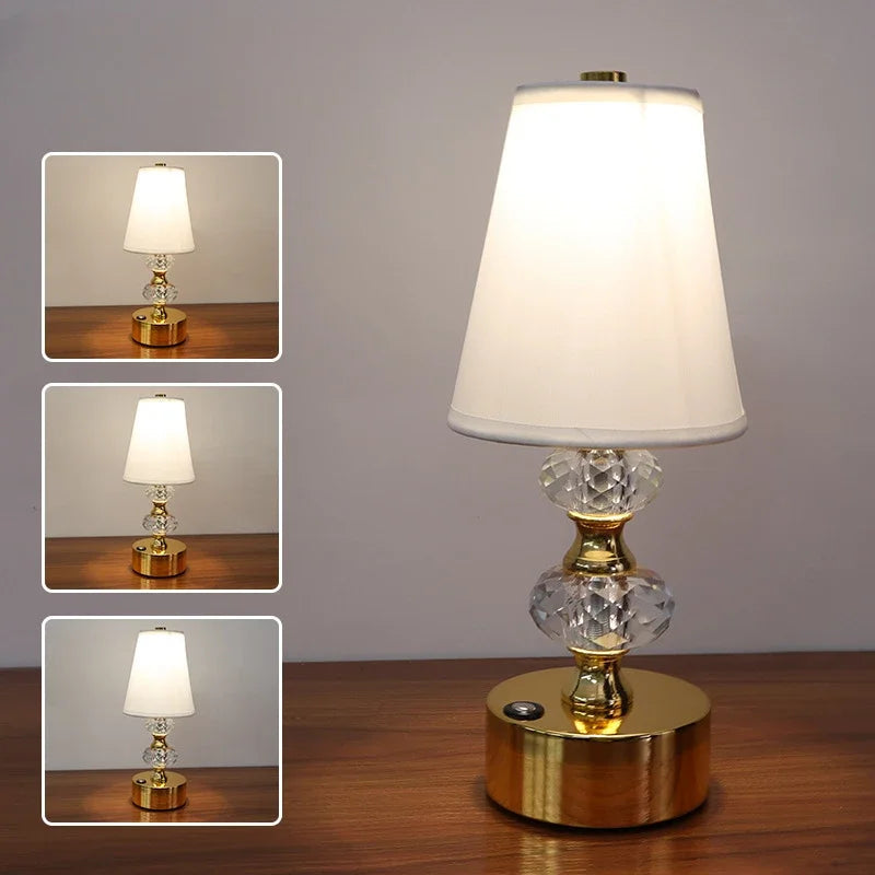 Decorative gold table lamp with faceted crystal accents on a wooden surface