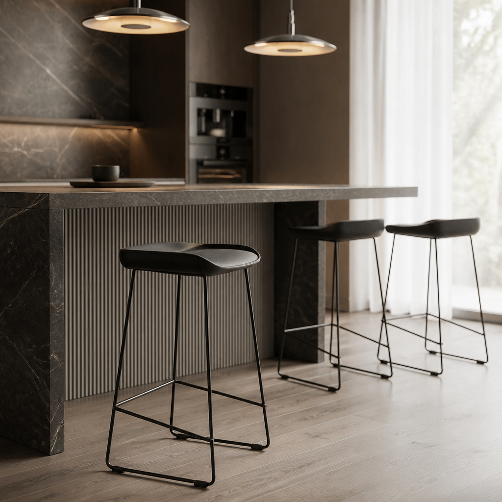 Modern kitchen with a bar counter and stools with chrome pendant lights hanging.