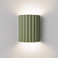 Sage green ribbed resin wall lamp with minimalist fluted design.