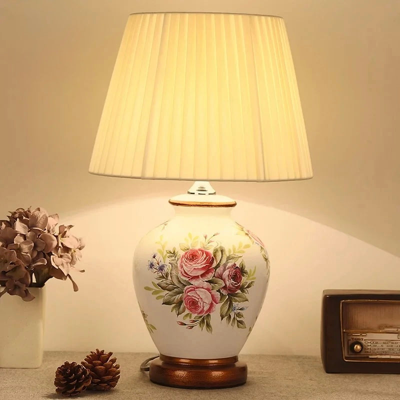 Ivory ceramic table lamp with pink rose bouquet design and pleated cream shade