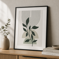 Minimal botanical canvas print with dark green leaves, soft arches, and fine curved line details.