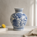 Blue and white floral-patterned vase on a neutral background