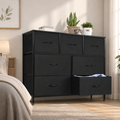 Black 7-drawer fabric dresser with one drawer open showing folded clothes