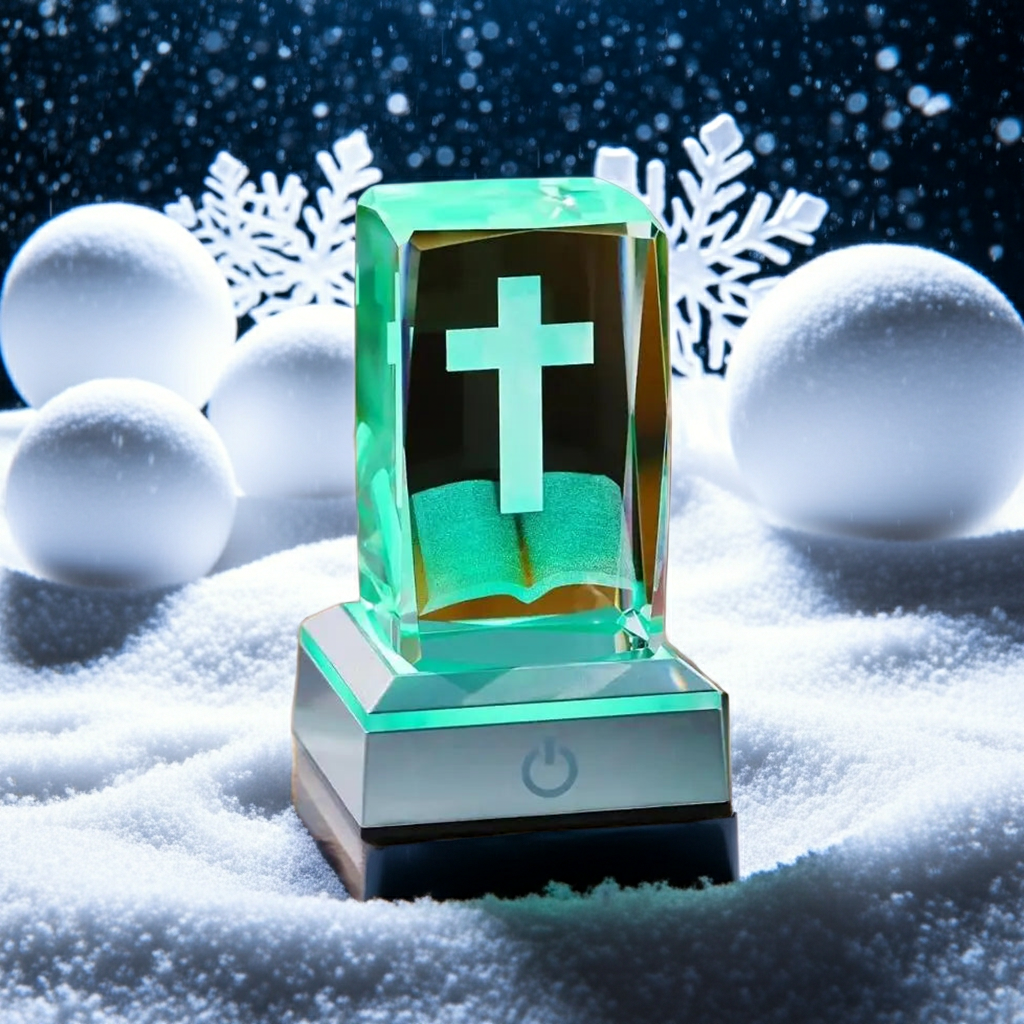 Decorative glass item with a cross on a snowy background