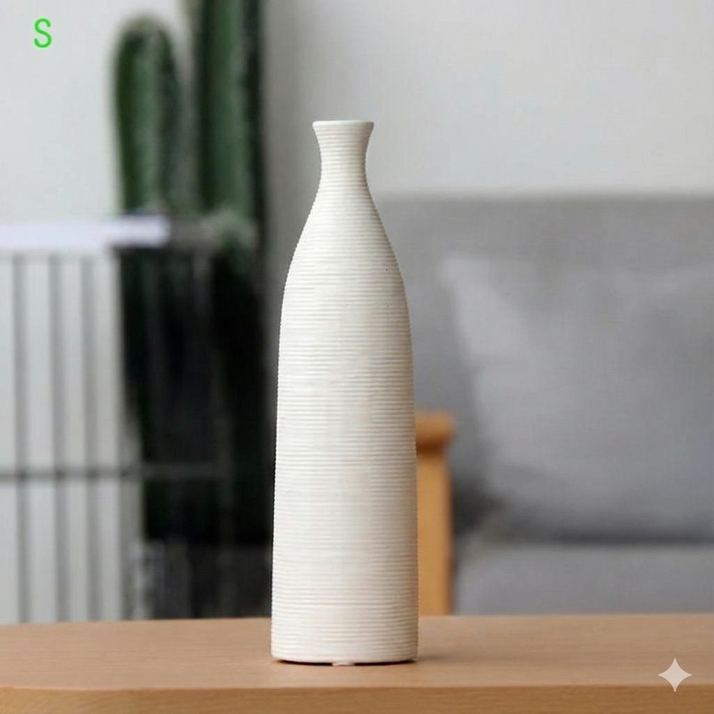 White ceramic vase on a wooden surface with a blurred indoor background