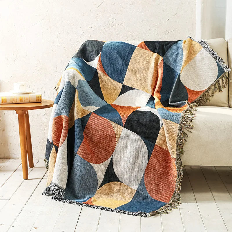 Retro Circles geometric throw blanket draped over an armchair
