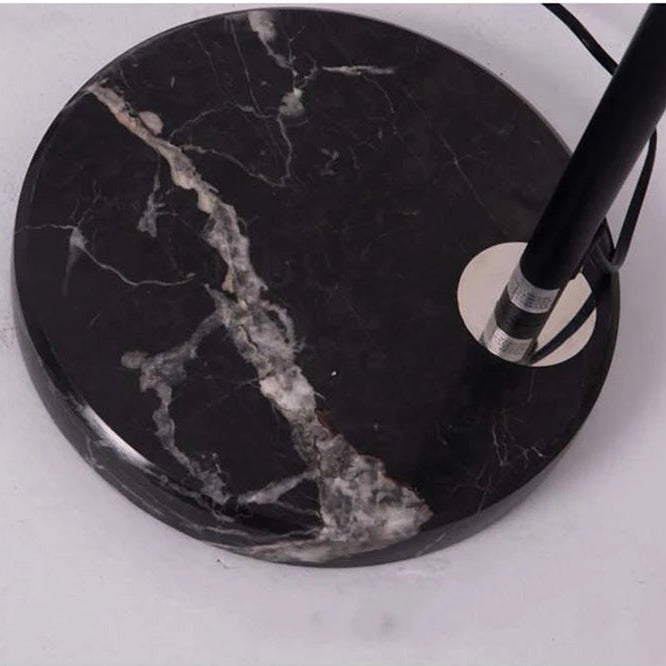 Close-up of the heavy black marble-effect base and black metal stem.