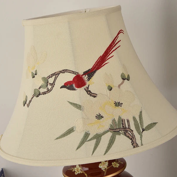 Lampshade with embroidered design of a bird on a branch