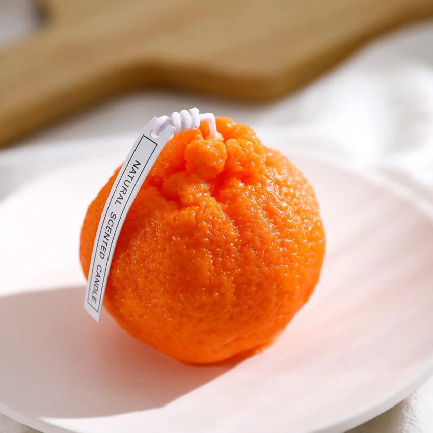 Orange bath bomb with a label on a white plate