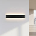 Black minimalist LED wall light with soft up and down glow on a white wall