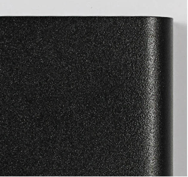 Close-up of black textured aluminium light cover.
