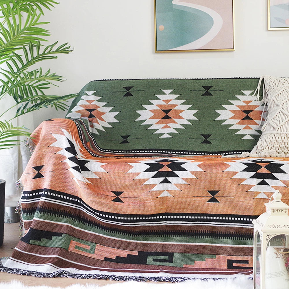 Sage Diamond Aztec throw covering a sofa beside a potted palm plant