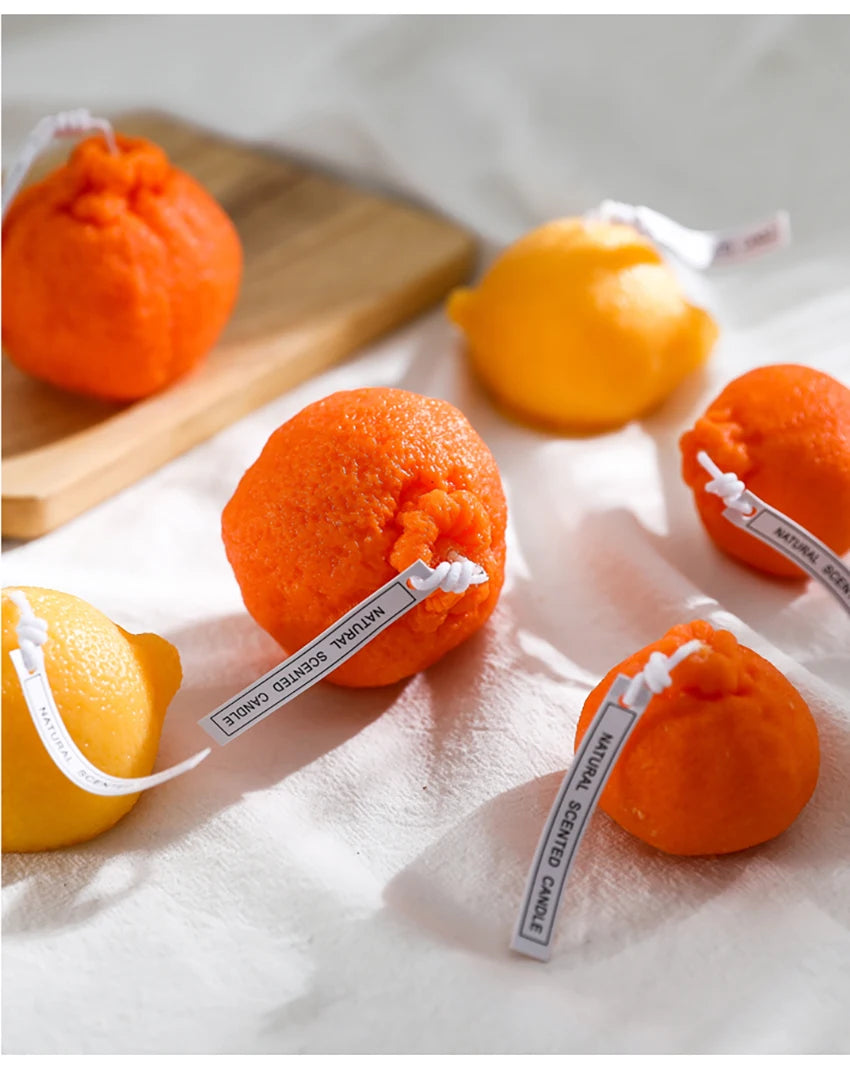 Orange-colored balls with strings on a white surface