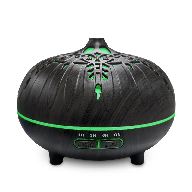 Black and green essential oil diffuser on a white background