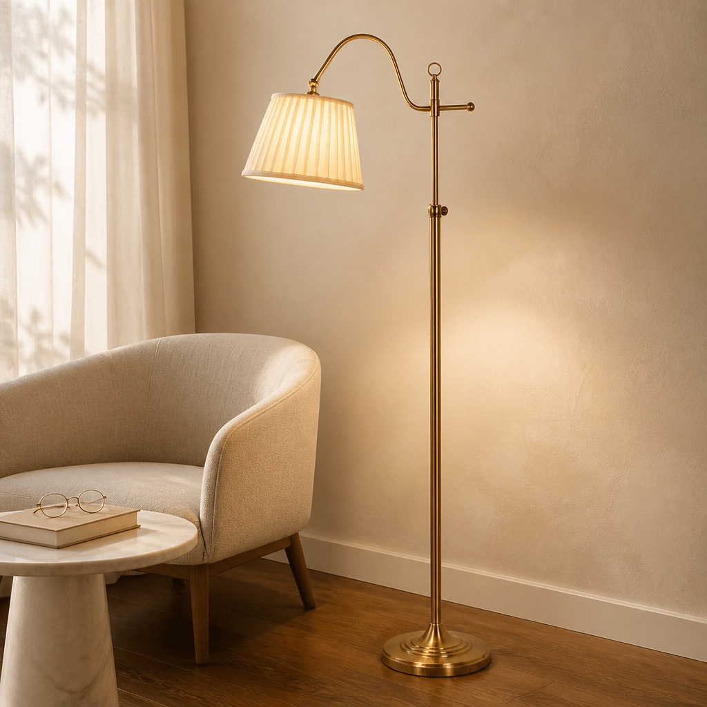 Antique metal-look floor lamp with pleated fabric shade beside an upholstered chair.