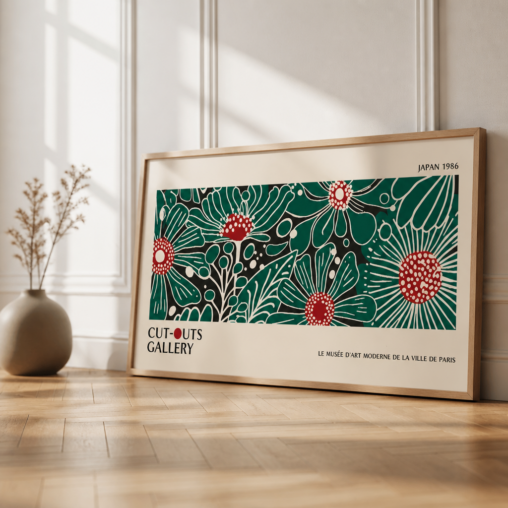 Wide floral gallery poster print with green and red botanical artwork leaning against a wall in a framed room setting.