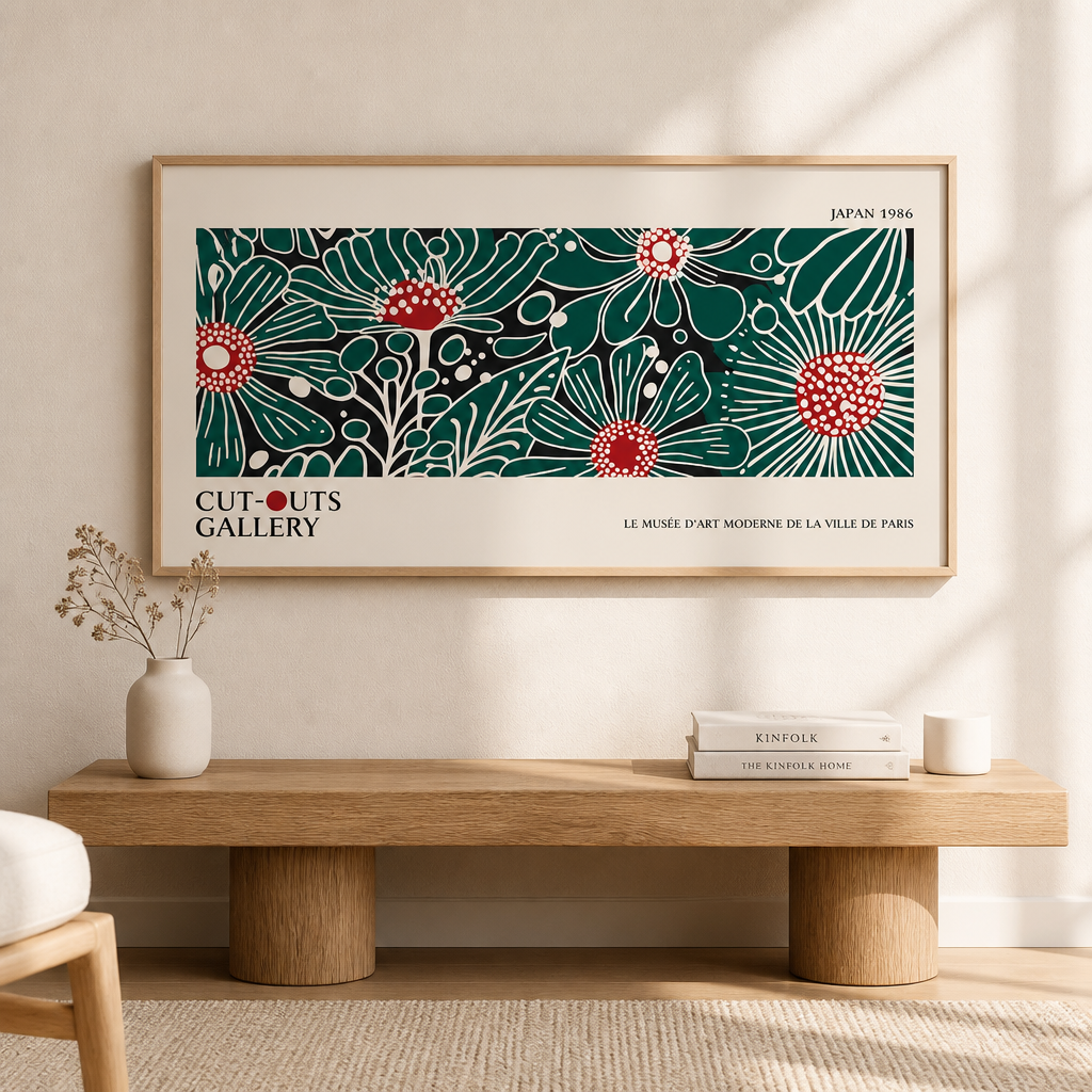 Wide floral gallery poster print with green and red botanical artwork leaning against a wall in a framed room setting.