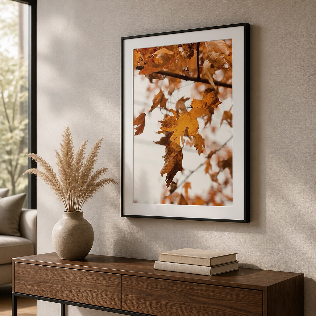 Autumn canvas print showing orange leaves hanging from branches against a pale background.
