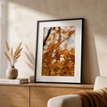 Autumn canvas print showing leaves on a branch with a blurred seasonal background.