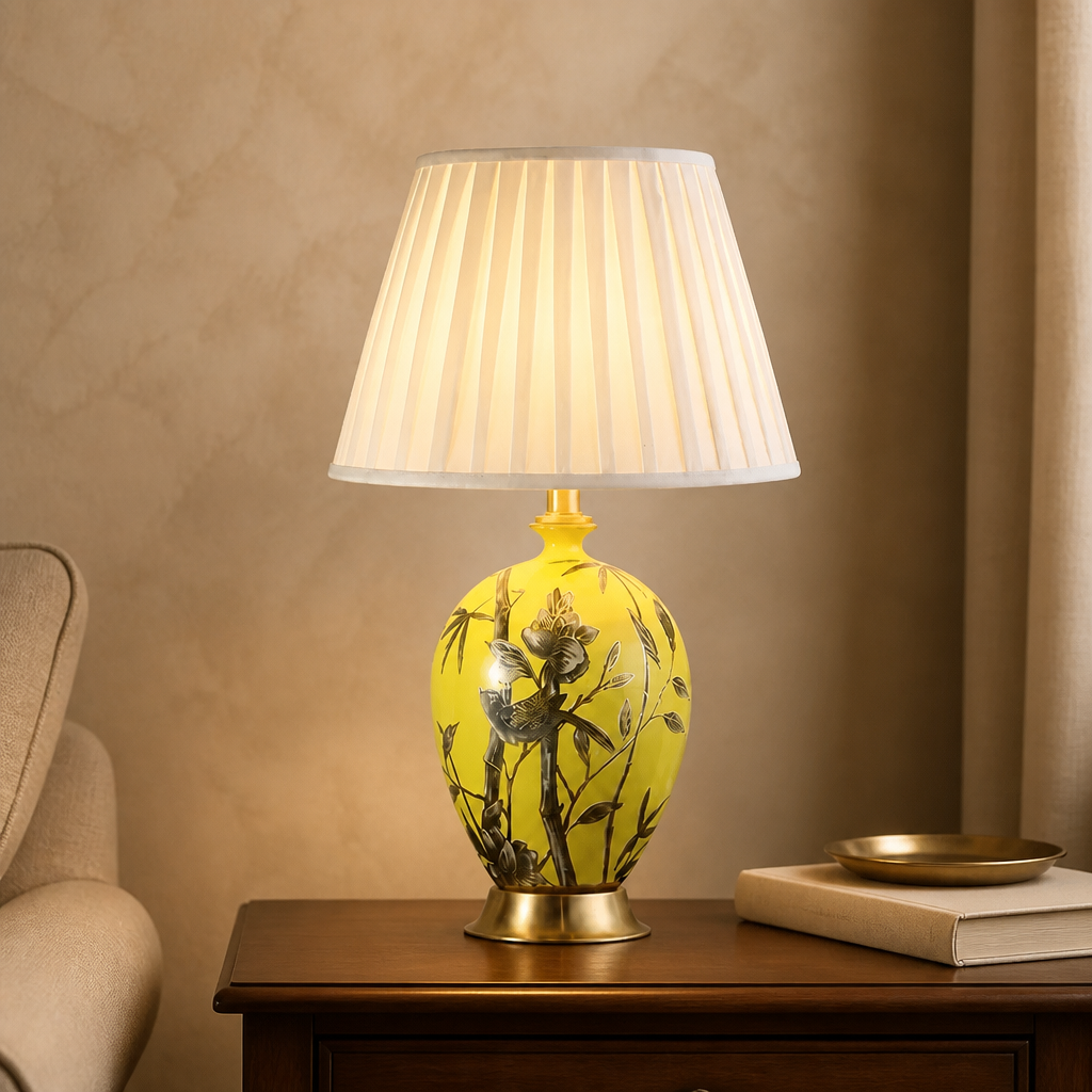 Yellow ceramic floral table lamp with a curved fabric shade and a height of 55 cm