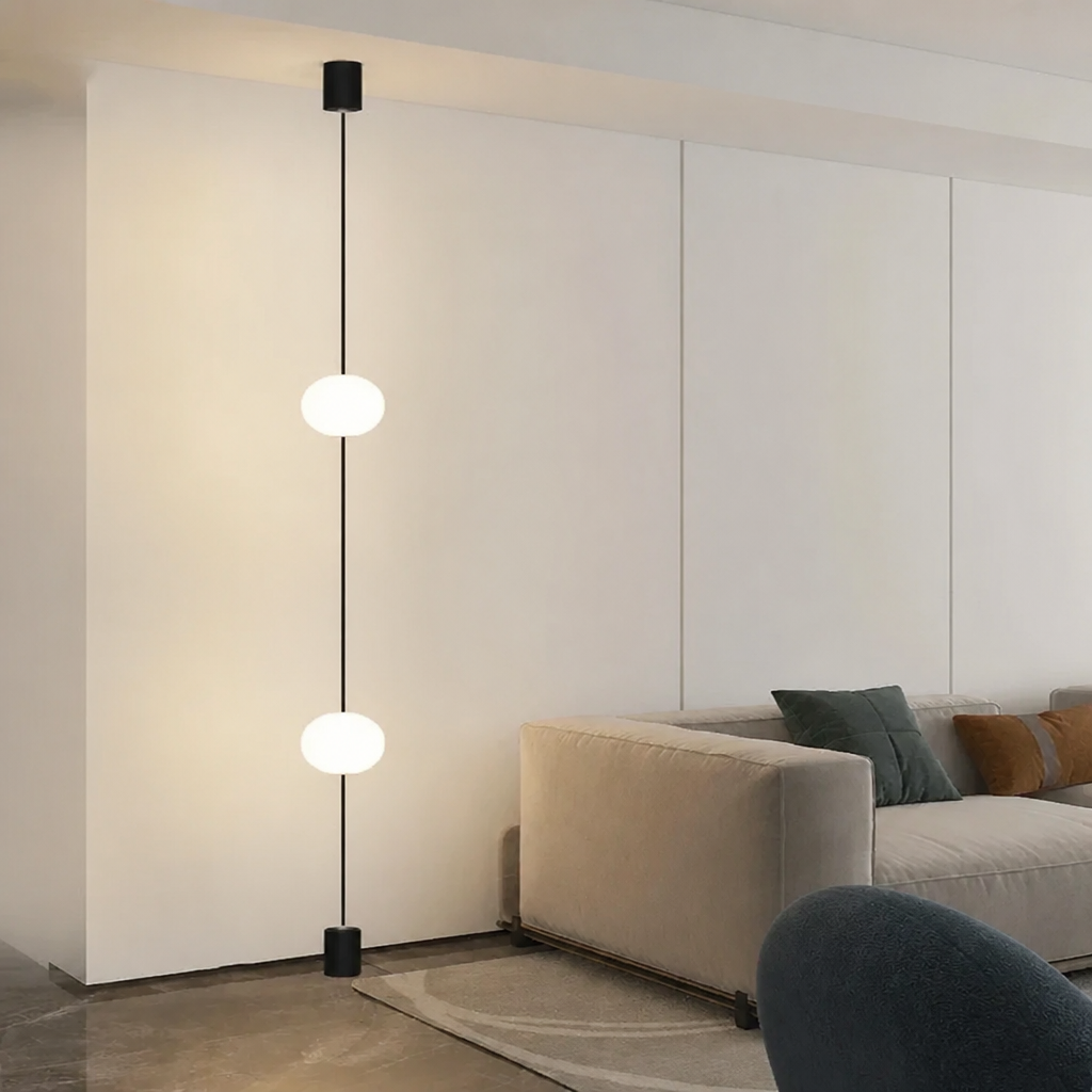 Minimalist living room with 2-head floor-to-ceiling globe pendant light against white wall