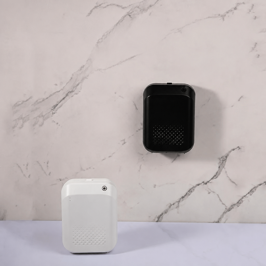 Black diffuser wall-mounted on marble surface, white diffuser placed flat on a shelf below