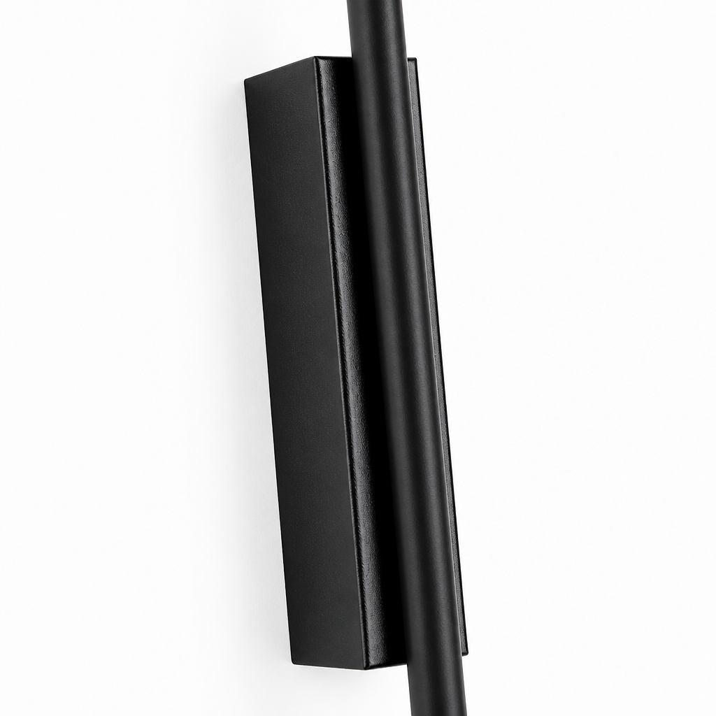Close-up of thickened black aluminium wall lamp bracket mounted on white wall