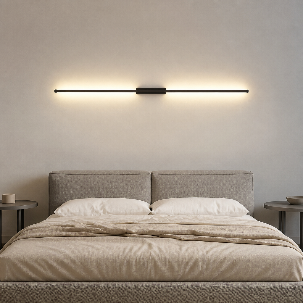 Single vertical black line bar wall lamp with warm glow above a modern bedroom scene.
