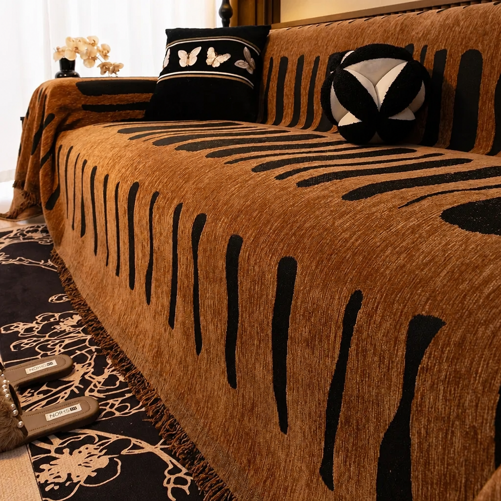 Brown chenille sofa cover with brushstroke stripe pattern draped over a three-seat sofa