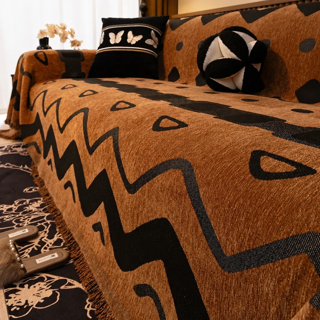 Brown chenille sofa cover with zigzag abstract pattern draped over a sofa in a styled living room