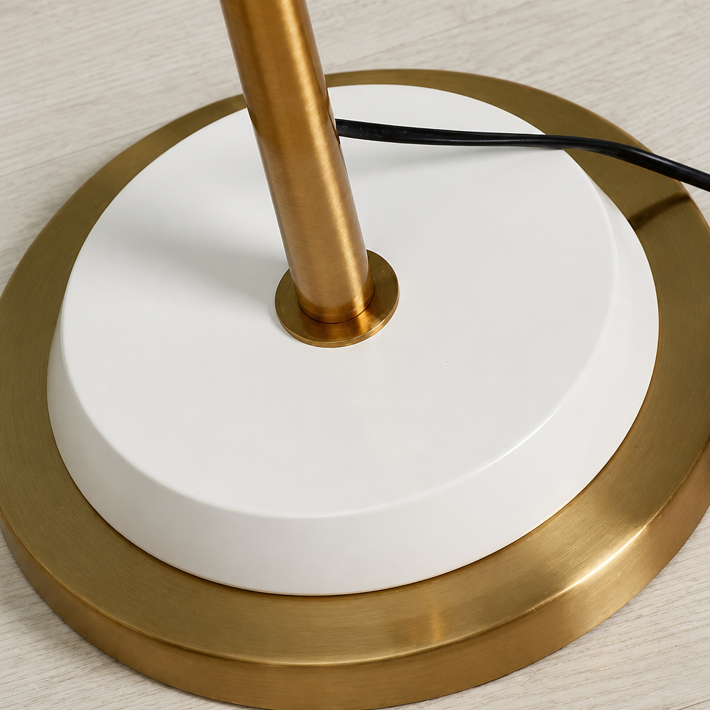 Close-up of a lamp base with gold and white design on a neutral background