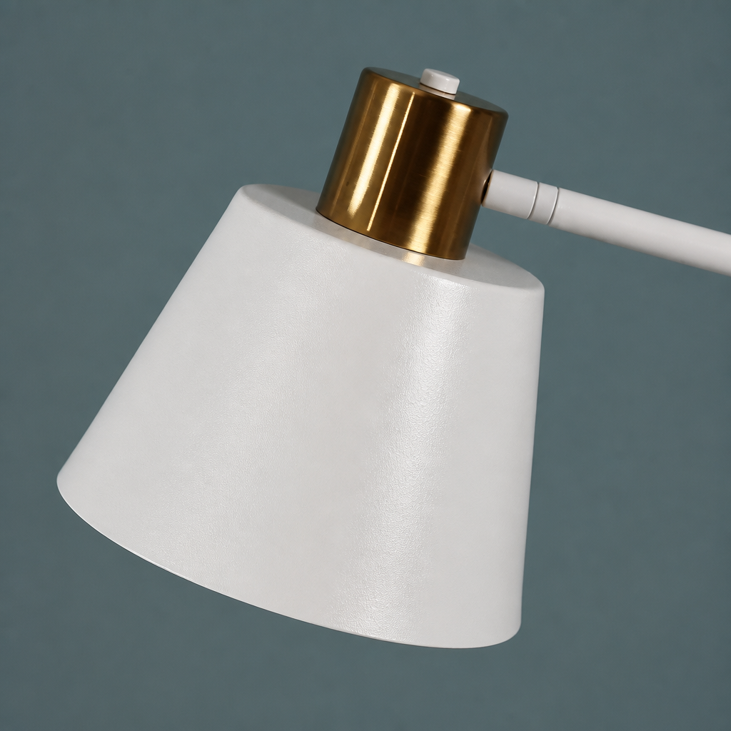 White lampshade with gold top on a dark gray background