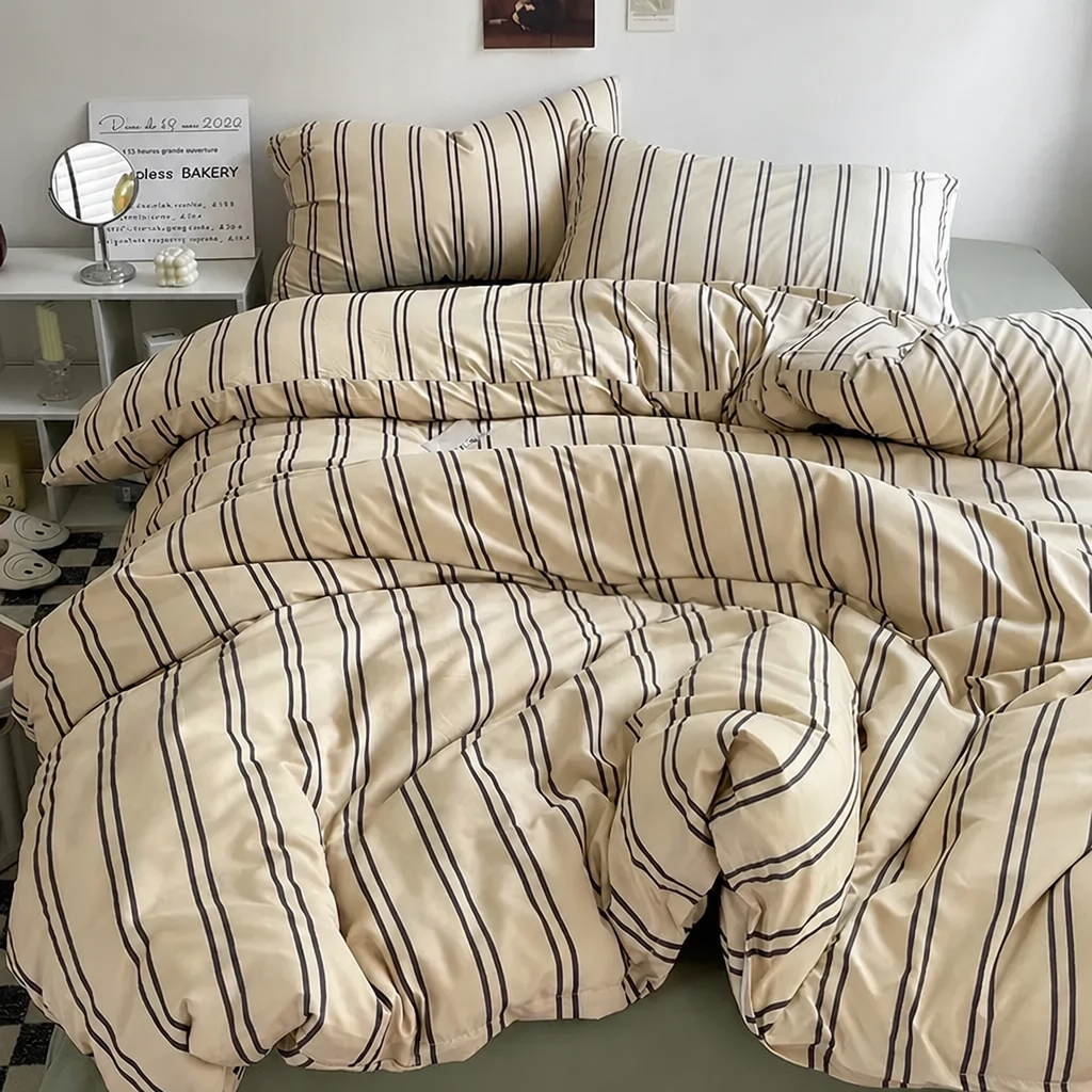 Beige-and-brown striped bedding set on a bed in a room.