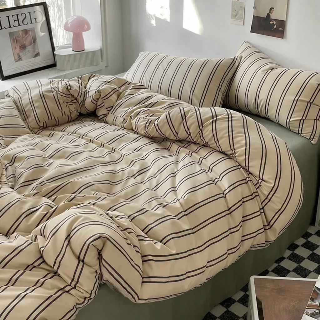 Beige-and-brown striped bedding set on a bed in a room.